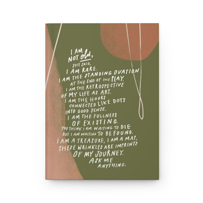 Front view of hardcover journal with beautiful abstract green and pink art featuring the poem, “I Am Not Old” by Samantha Reynolds on the cover.