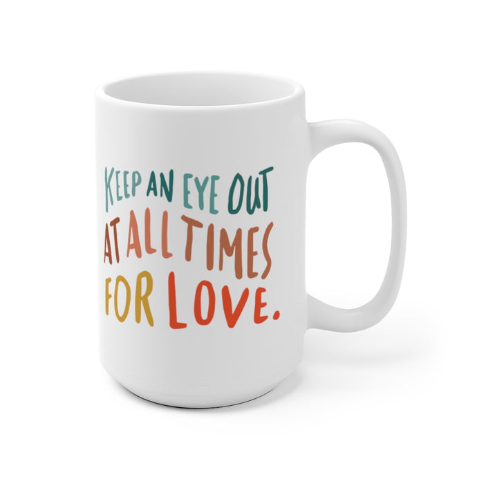 Whimsical 15 oz white coffee mug hand-lettered with a big inspiring quote about love in bright primary colors. 