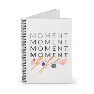 Spiral notebook, standing up on table, showing the cover with an inspiring statement about cherishing your life. 