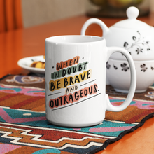 Load image into Gallery viewer,  Trendy quote mug on colorful runner in front of teapot. Quote on mug reads: “When in doubt, be brave and outrageous.”
