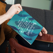 Load image into Gallery viewer, Woman putting her journal in her purse. Spiral journal has original quote about fears on the cover, with painted whales.
