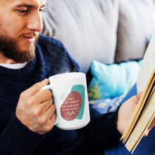Load image into Gallery viewer, Hipster guy reading a book, holding a creative white coffee mug featuring a motivational quote and abstract shapes. 
