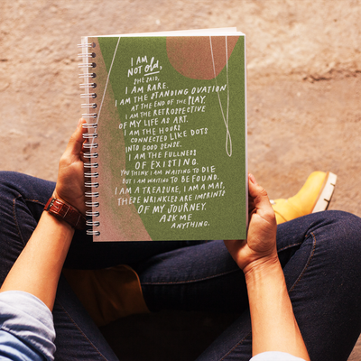 Popular poem, “I Am Not Old,” by Samantha Reynolds printed on cover of beautiful olive green spiral notebook. 