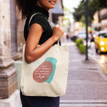 Load image into Gallery viewer, Woman on a city street, holding an off-white tote bag over her shoulder with beautiful word art featuring a motivational quote.
